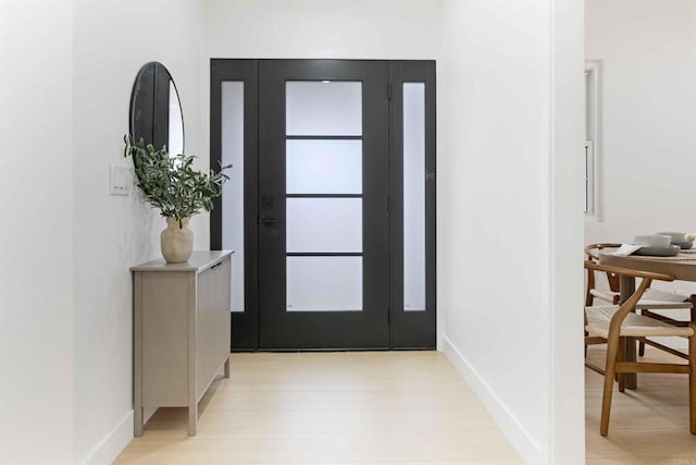 entrance foyer featuring baseboards and light wood-type flooring