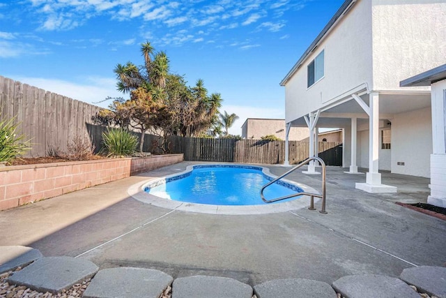 view of swimming pool with a patio area and a fenced backyard