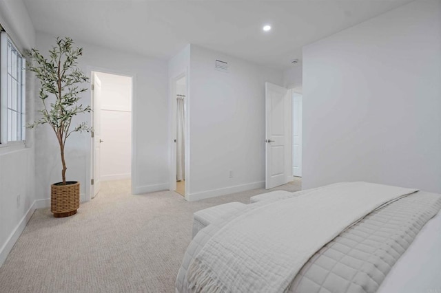 bedroom with baseboards, recessed lighting, and light carpet