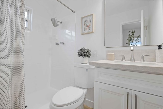 full bath featuring toilet, a shower with shower curtain, and vanity