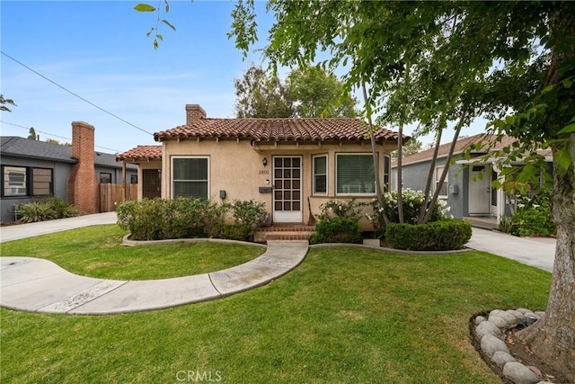1801 N Ross St, Santa Ana, CA 92706 - mediterranean / spanish house with a tile roof, stucco siding, and a chimney