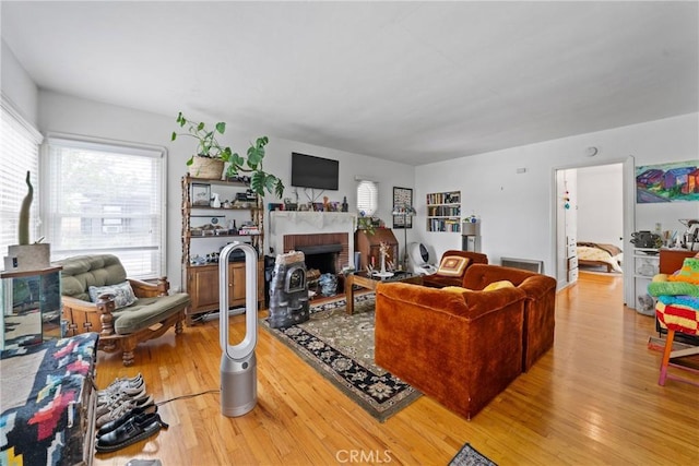 1801 N Ross St, Santa Ana, CA 92706 - living room featuring healthy amount of natural light, light wood-type flooring, and a fireplace