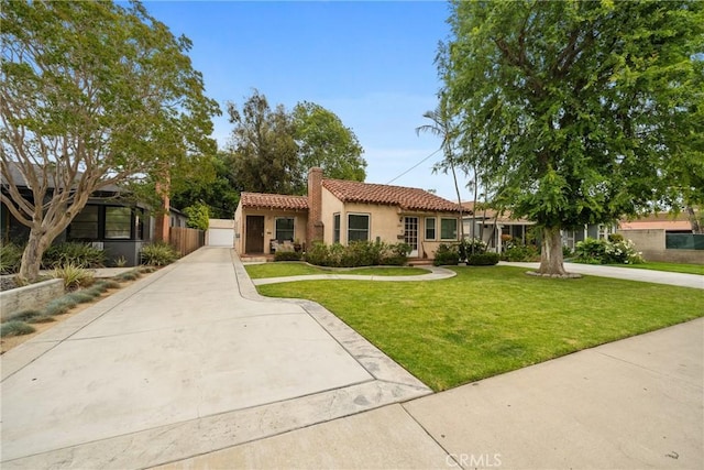 1801 N Ross St, Santa Ana, CA 92706 - mediterranean / spanish-style house with a tile roof, a chimney, stucco siding, a front yard, and a garage