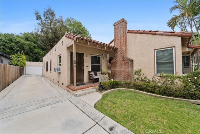 1801 N Ross St, Santa Ana, CA 92706 - mediterranean / spanish house with stucco siding, a tiled roof, a chimney, and a detached garage