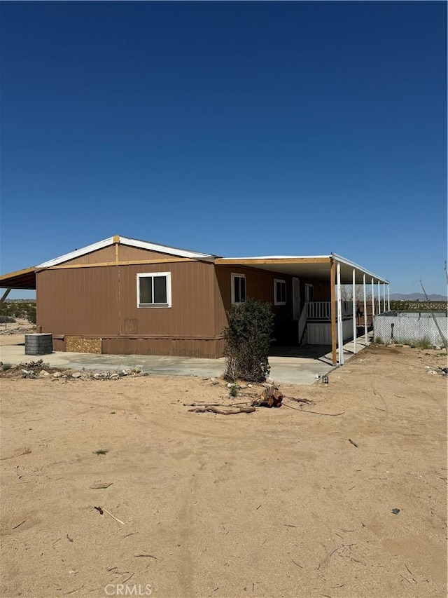 rear view of property with central AC