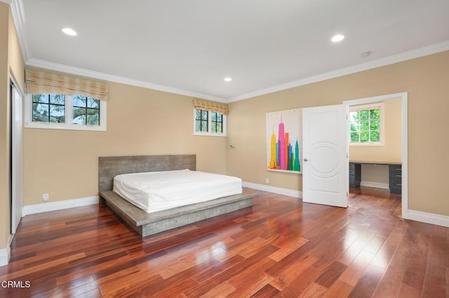 bedroom featuring multiple windows, baseboards, wood finished floors, ornamental molding, and recessed lighting