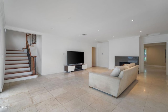 living area featuring stairway, light tile patterned flooring, a lit fireplace, recessed lighting, and crown molding