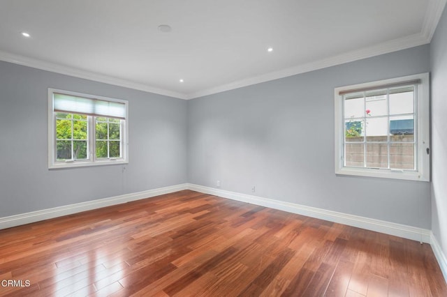 unfurnished room with hardwood / wood-style floors, ornamental molding, baseboards, and recessed lighting