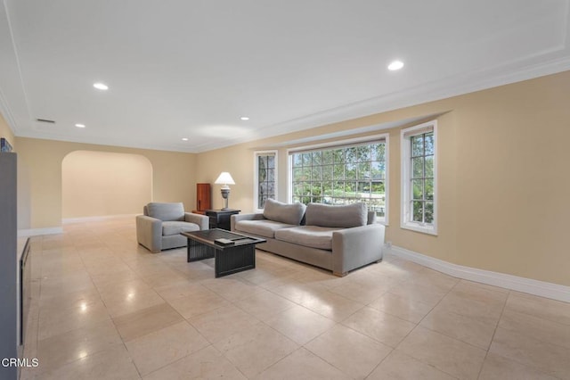 living room with arched walkways, crown molding, baseboards, recessed lighting, and light tile patterned floors