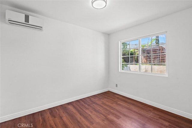 2613 Millbrae Ave, Duarte, CA 91010 - spare room with a wall unit AC, dark wood-style floors, and baseboards