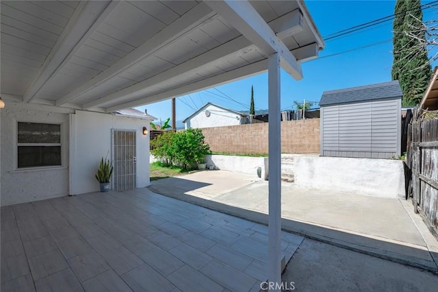 2613 Millbrae Ave, Duarte, CA 91010 - view of patio / terrace with an outbuilding, a storage unit, and fence