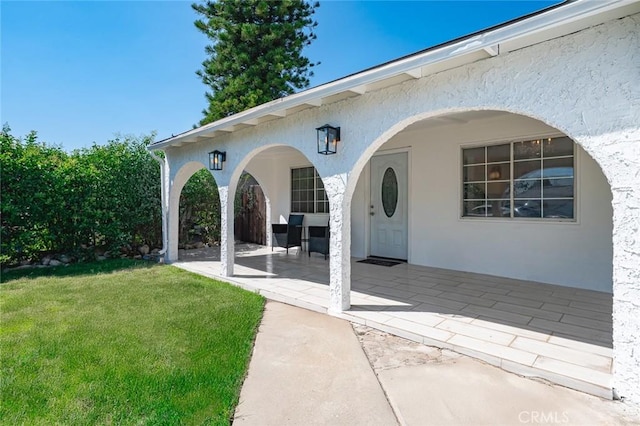 2613 Millbrae Ave, Duarte, CA 91010 - property entrance with stucco siding, a patio area, and a lawn