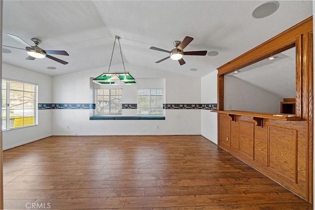 10059 Rock Hl, Moreno Valley, CA 92557 - unfurnished living room with vaulted ceiling, a ceiling fan, plenty of natural light, and dark wood-style flooring