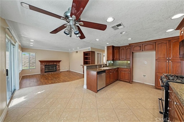 10059 Rock Hl, Moreno Valley, CA 92557 - kitchen with appliances with stainless steel finishes, a sink, baseboards, ceiling fan, and a peninsula