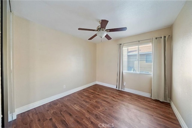 10059 Rock Hl, Moreno Valley, CA 92557 - empty room with dark wood finished floors, a ceiling fan, and baseboards