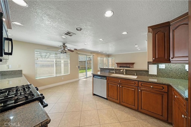 10059 Rock Hl, Moreno Valley, CA 92557 - kitchen featuring stainless steel dishwasher, a sink, a ceiling fan, baseboards, and a peninsula