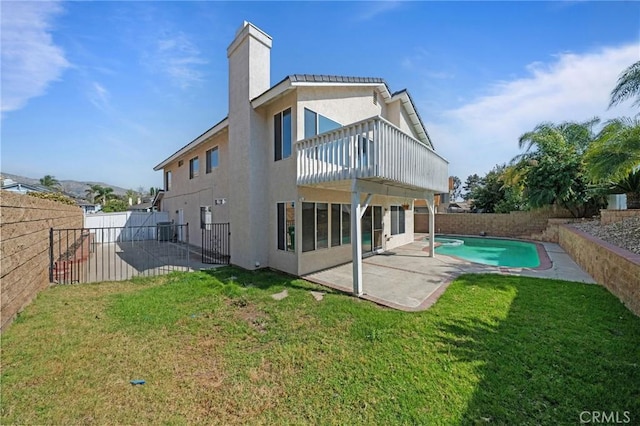10059 Rock Hl, Moreno Valley, CA 92557 - rear view of property with a patio area, stucco siding, and a chimney