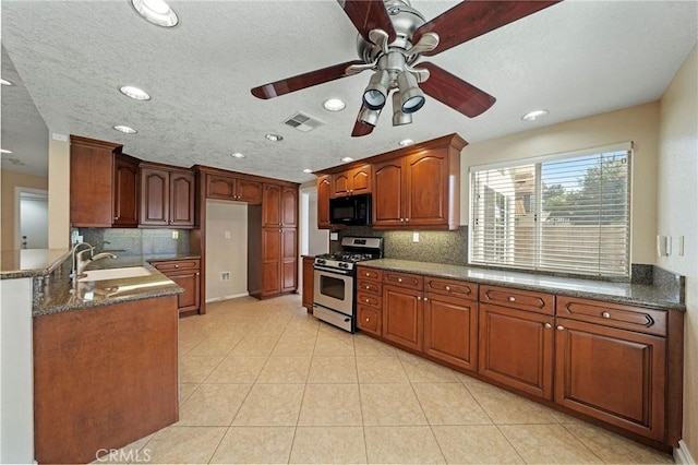 10059 Rock Hl, Moreno Valley, CA 92557 - kitchen featuring stainless steel gas range, black microwave, ceiling fan, recessed lighting, and tasteful backsplash
