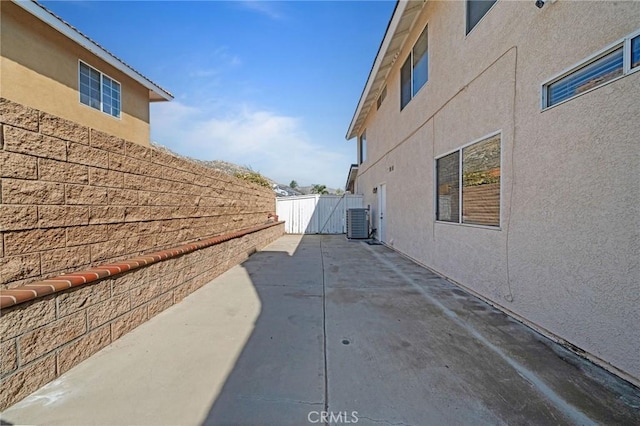 10059 Rock Hl, Moreno Valley, CA 92557 - view of property exterior with stucco siding, central AC, fence, and a patio