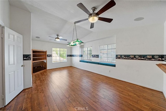 10059 Rock Hl, Moreno Valley, CA 92557 - unfurnished living room featuring ceiling fan, lofted ceiling, hardwood / wood-style floors, and baseboards