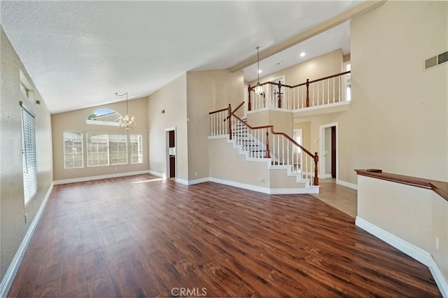 10059 Rock Hl, Moreno Valley, CA 92557 - unfurnished living room with a chandelier, wood finished floors, stairs, high vaulted ceiling, and baseboards