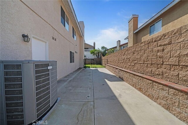 10059 Rock Hl, Moreno Valley, CA 92557 - view of property exterior with central AC, fence, stucco siding, and a patio