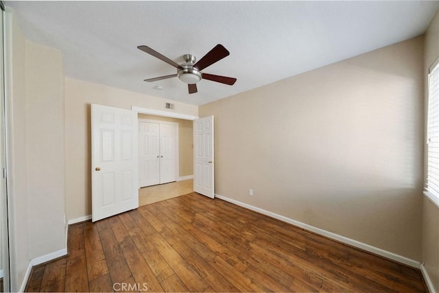 10059 Rock Hl, Moreno Valley, CA 92557 - unfurnished bedroom featuring hardwood / wood-style floors, baseboards, and multiple windows