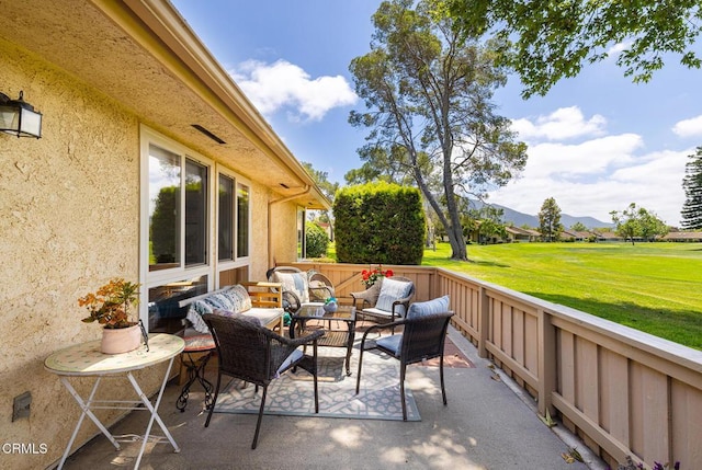 view of patio with an outdoor living space and a mountain view