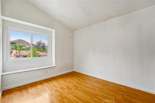 4176 Canyonside Cir, Jurupa Valley, CA 92509 - unfurnished room featuring light wood-style flooring, lofted ceiling, and baseboards