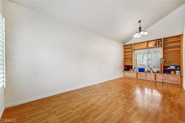 4176 Canyonside Cir, Jurupa Valley, CA 92509 - unfurnished living room featuring a chandelier, light wood-type flooring, baseboards, built in features, and high vaulted ceiling