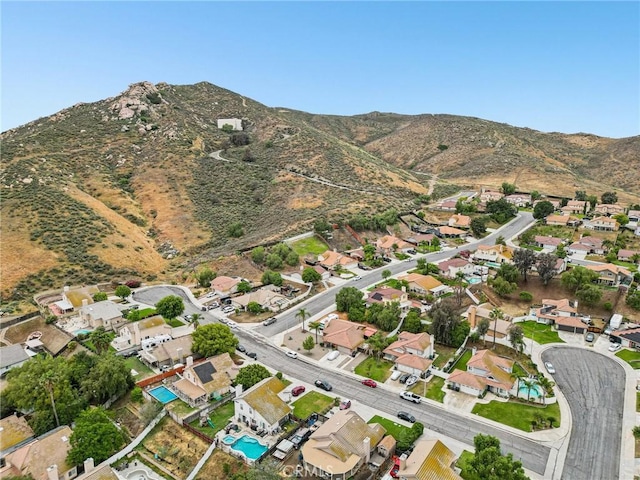 4176 Canyonside Cir, Jurupa Valley, CA 92509 - aerial view of property's location with a mountain backdrop and nearby suburban area