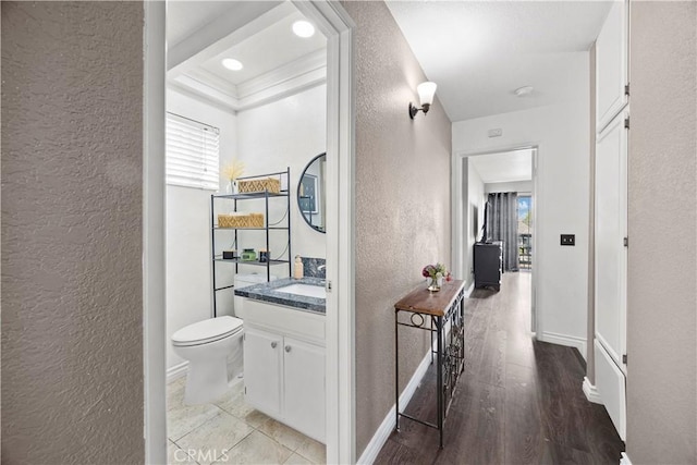 1992 Moonbeam Cir, Upland, CA 91784 - corridor featuring a textured wall, light wood-type flooring, baseboards, and a sink