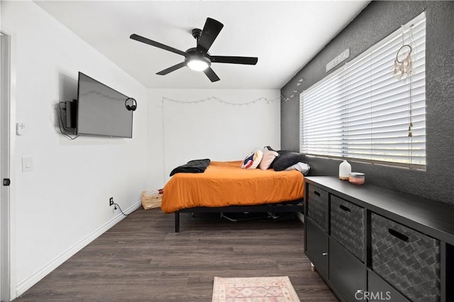 bedroom with dark wood-style floors and ceiling fan