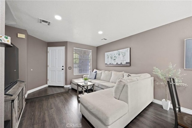 living area with dark wood-style flooring, baseboards, and recessed lighting