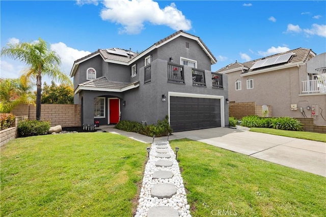 traditional home with a balcony, an attached garage, stucco siding, concrete driveway, and solar panels