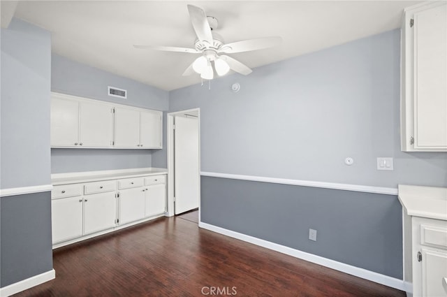 kitchen featuring a ceiling fan, baseboards, white cabinetry, and light countertops