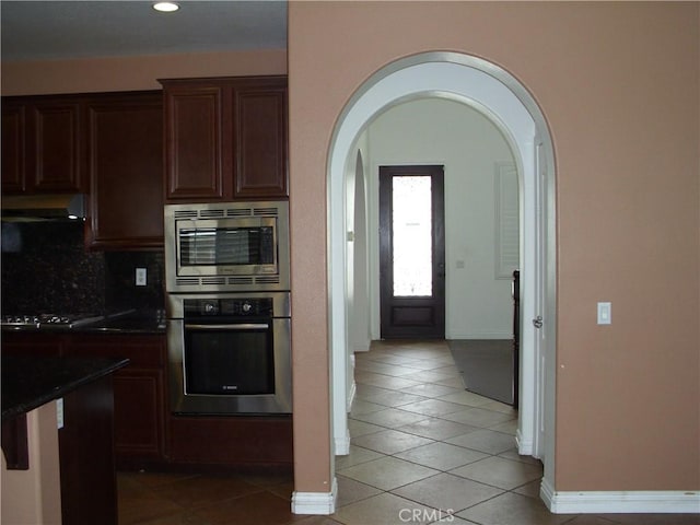 1110 Laurelhurst, San Jacinto, CA 92582 - kitchen with stainless steel appliances, light tile patterned flooring, arched walkways, dark countertops, and recessed lighting