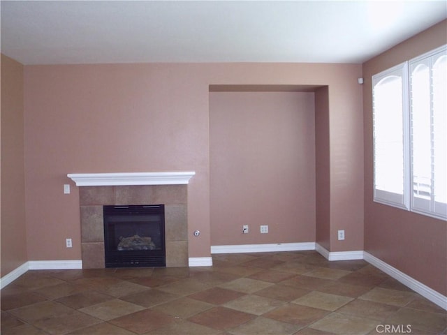 1110 Laurelhurst, San Jacinto, CA 92582 - unfurnished living room with a tiled fireplace, tile patterned floors, and baseboards