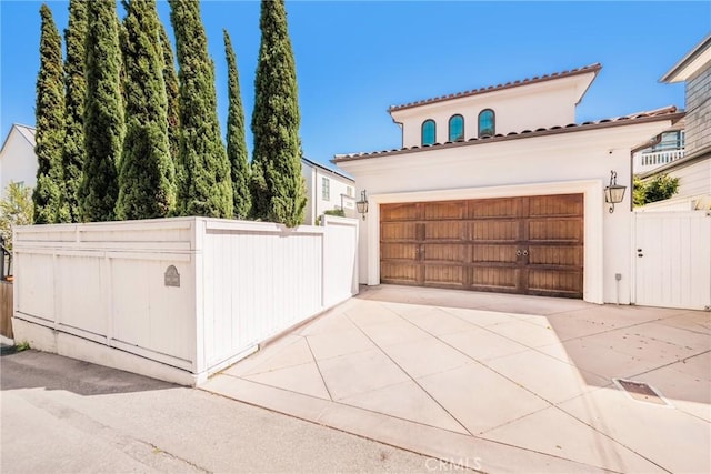 717 35th St, Manhattan Beach, CA 90266 - view of front of property featuring a gate, stucco siding, fence, and a garage