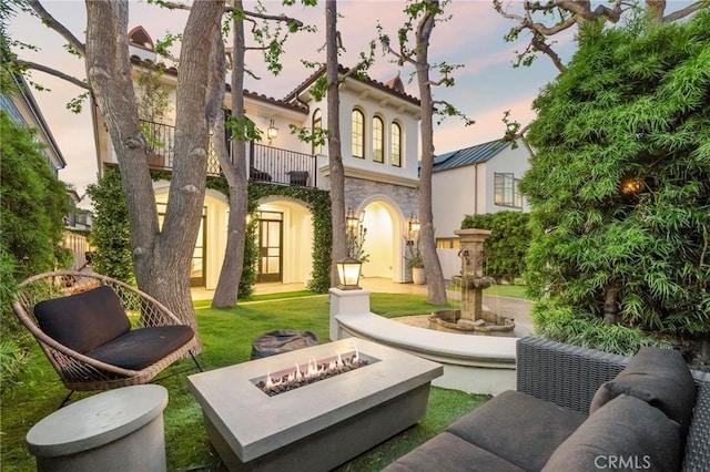717 35th St, Manhattan Beach, CA 90266 - back of house featuring an outdoor fire pit, stucco siding, a balcony, stone siding, and a tiled roof