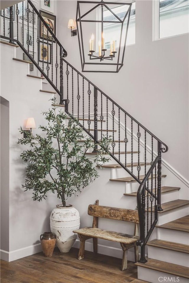 717 35th St, Manhattan Beach, CA 90266 - stairway featuring wood finished floors, a chandelier, and baseboards