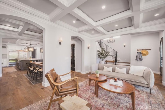 717 35th St, Manhattan Beach, CA 90266 - living room featuring arched walkways, coffered ceiling, stairs, a chandelier, and baseboards