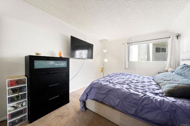 bedroom featuring carpet floors, a textured ceiling, and vaulted ceiling
