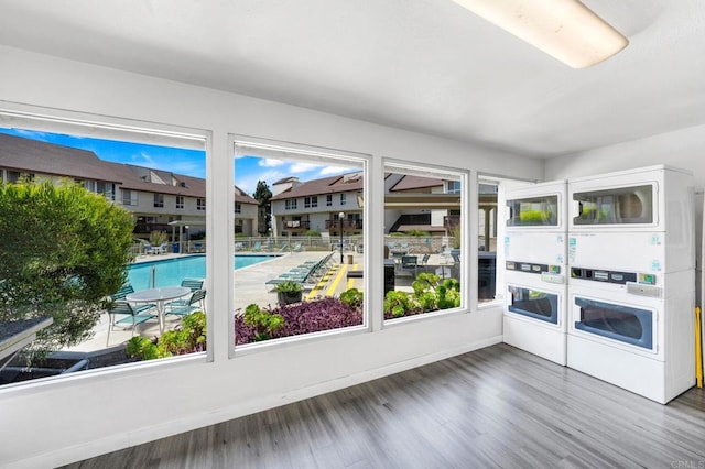unfurnished sunroom with estacked washer and dryer