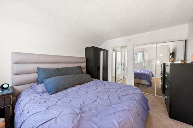 bedroom featuring light carpet, a closet, and a textured ceiling
