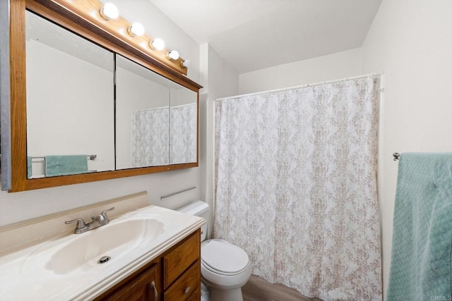 bathroom featuring toilet, vanity, wood finished floors, and a shower with shower curtain