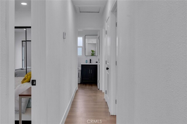1925 N Marengo Ave, Pasadena, CA 91103 - hallway with wood finished floors, baseboards, a textured wall, and a sink