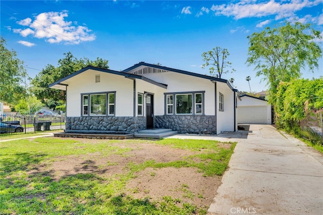 1925 N Marengo Ave, Pasadena, CA 91103 - view of front of house with stone siding, fence, an outbuilding, and a detached garage