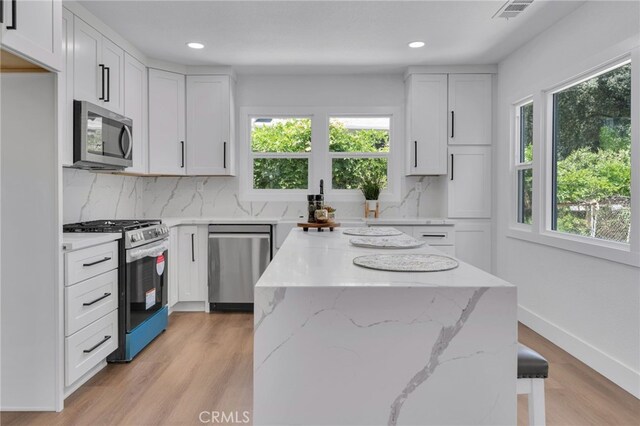1925 N Marengo Ave, Pasadena, CA 91103 - kitchen featuring appliances with stainless steel finishes, plenty of natural light, a kitchen island, backsplash, and recessed lighting