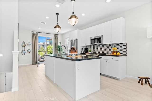 612 Prickly Pear Way, Rancho Mission Viejo, CA 92694 - kitchen with dark countertops, appliances with stainless steel finishes, backsplash, a center island with sink, and recessed lighting